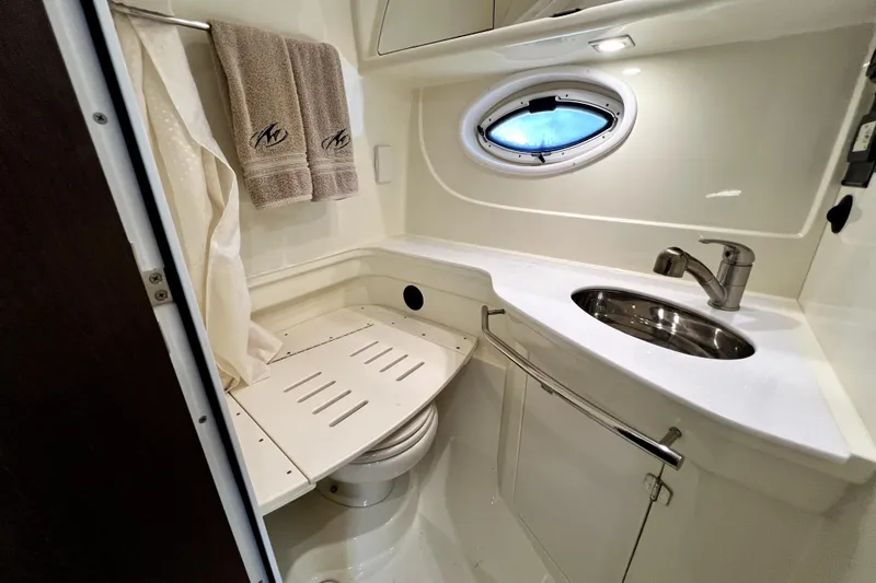 Slide: The Image of Bathroom interior of 2018 Monterey 355 Sport Yacht with sink and porthole window. - 66