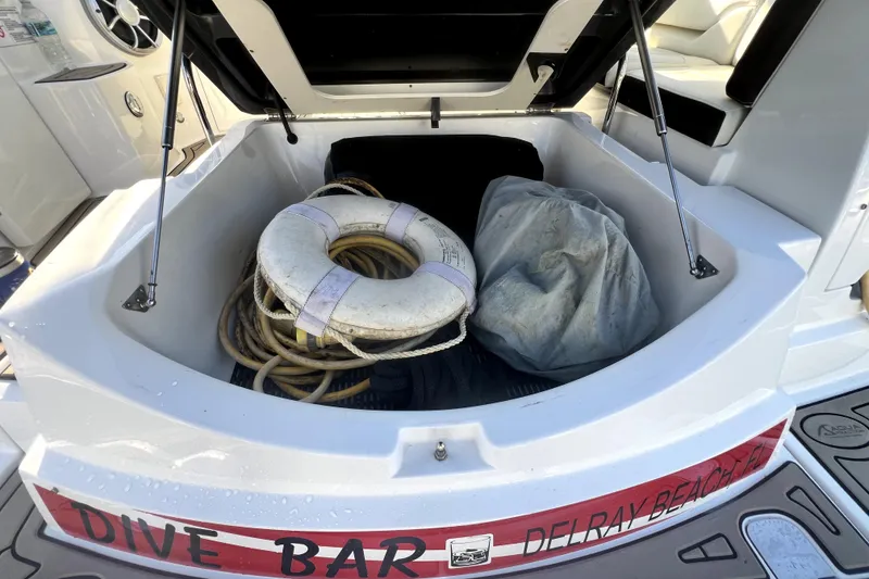 Slide: The Image of Open storage compartment on 2018 Monterey 355 Sport Yacht with life ring and ropes. - 30