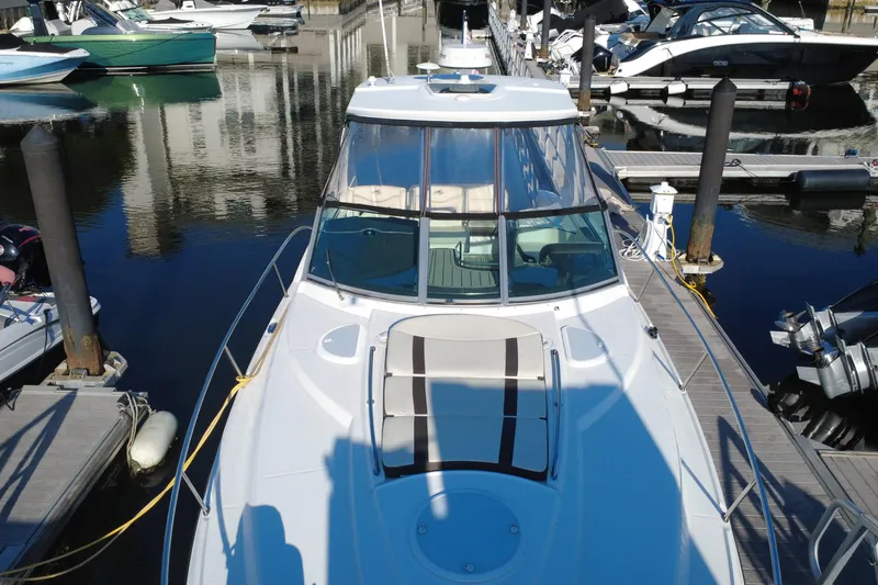 Slide: The Image of 2018 Monterey 355 Sport Yacht docked at marina, showcasing sleek design and spacious deck. - 19