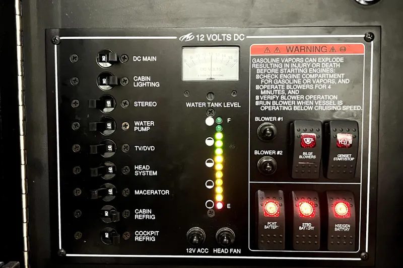 Slide: The Image of Control panel of a 2018 Monterey 355 Sport Yacht with warning labels and switches. - 74