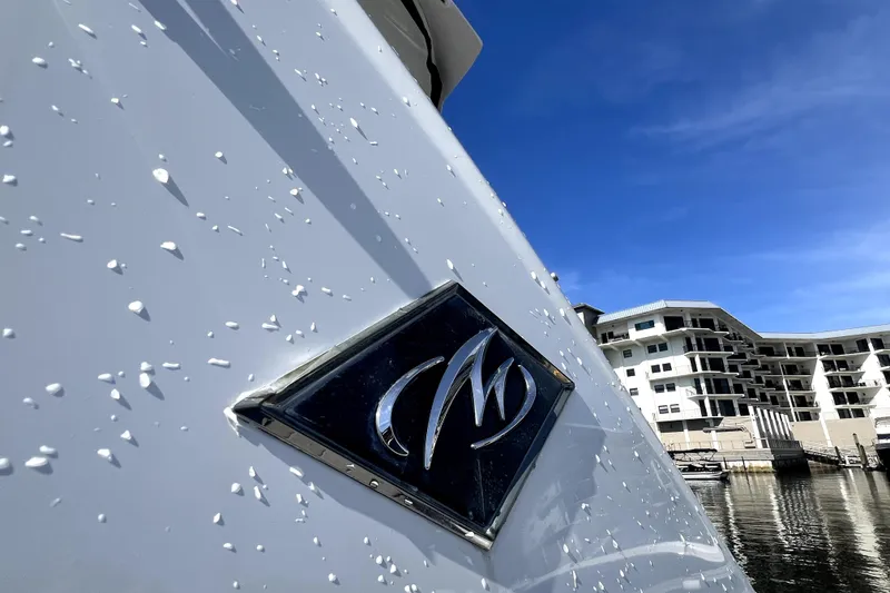 Slide: The Image of 2018 Monterey 355 Sport Yacht with logo, docked near modern waterfront buildings. - 41