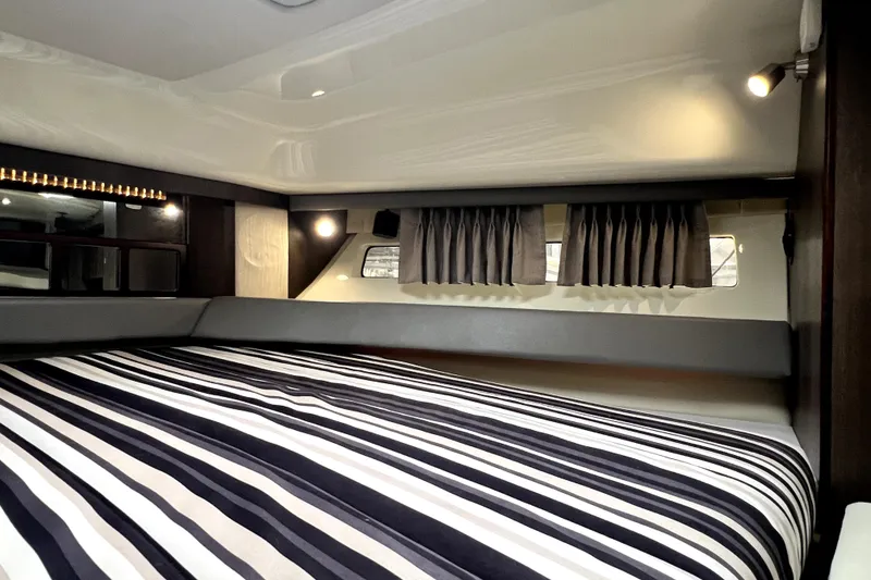 Slide: The Image of Interior cabin of 2018 Monterey 355 Sport Yacht with striped bedding and modern lighting. - 94