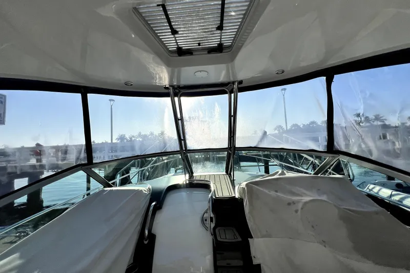 Slide: The Image of Interior view of a 2018 Monterey 355 Sport Yacht with marina backdrop. - 75