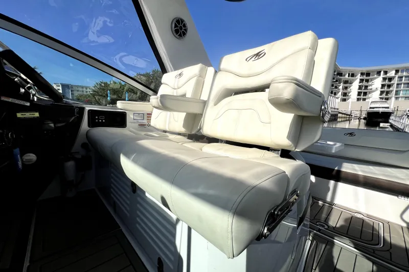 Slide: The Image of Interior of 2018 Monterey 355 Sport Yacht with luxurious white seating and modern dashboard. - 125