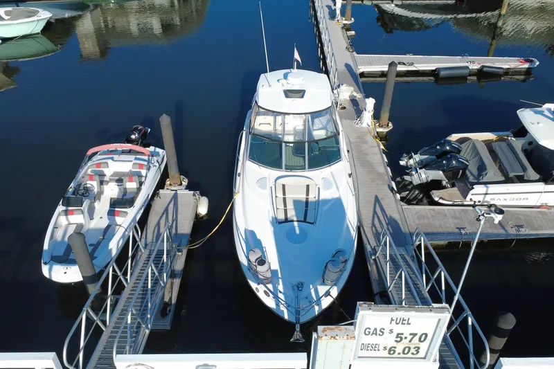 Slide: The Image of 2018 Monterey 355 Sport Yacht docked at marina, surrounded by boats, fuel prices visible. - 20