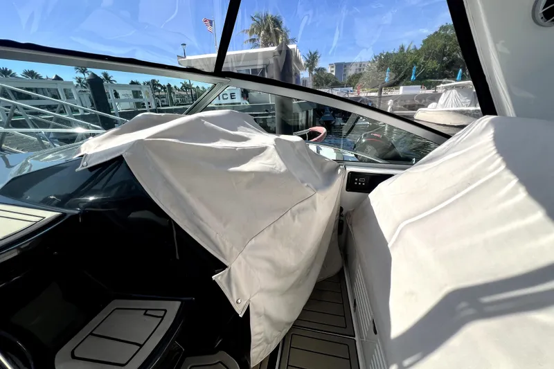 Slide: The Image of 2018 Monterey 355 Sport Yacht interior with covered seating, docked under sunny skies. - 43