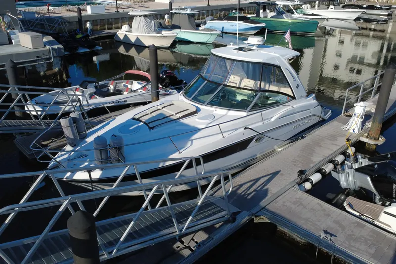 Slide: The Image of 2018 Monterey 355 Sport Yacht docked at marina, surrounded by other boats. - 17