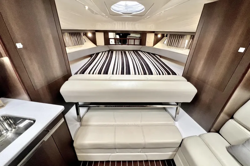 Slide: The Image of Luxurious interior of 2018 Monterey 355 Sport Yacht with elegant seating and striped bedding. - 53