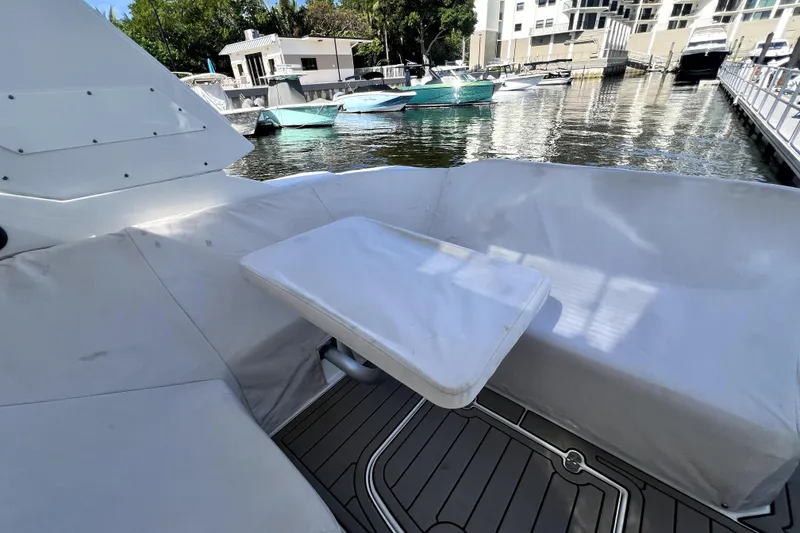 Slide: The Image of 2018 Monterey 355 Sport Yacht interior with covered seating and table, docked at marina. - 38