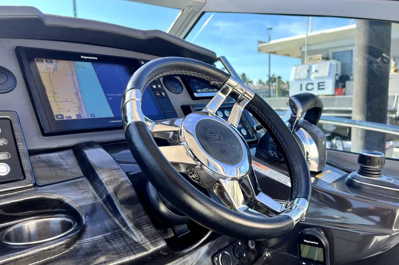 Slide: The Image of Steering wheel and dashboard of 2018 Monterey 355 Sport Yacht with navigation display. - 65