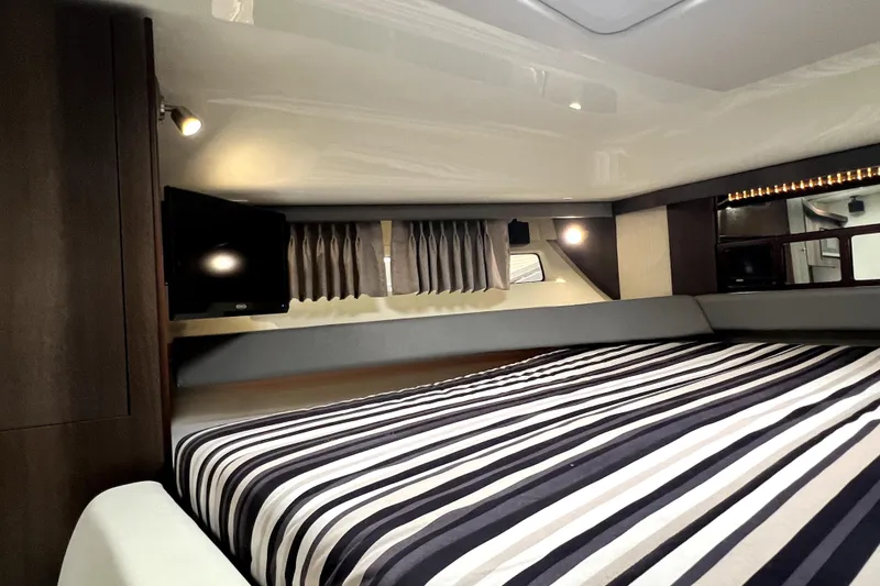 Slide: The Image of Interior of 2018 Monterey 355 Sport Yacht with striped bedding and modern lighting. - 95