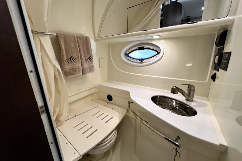 Slide: The Image of 2018 Monterey 355 Sport Yacht bathroom with sink, porthole, and towels. - 45