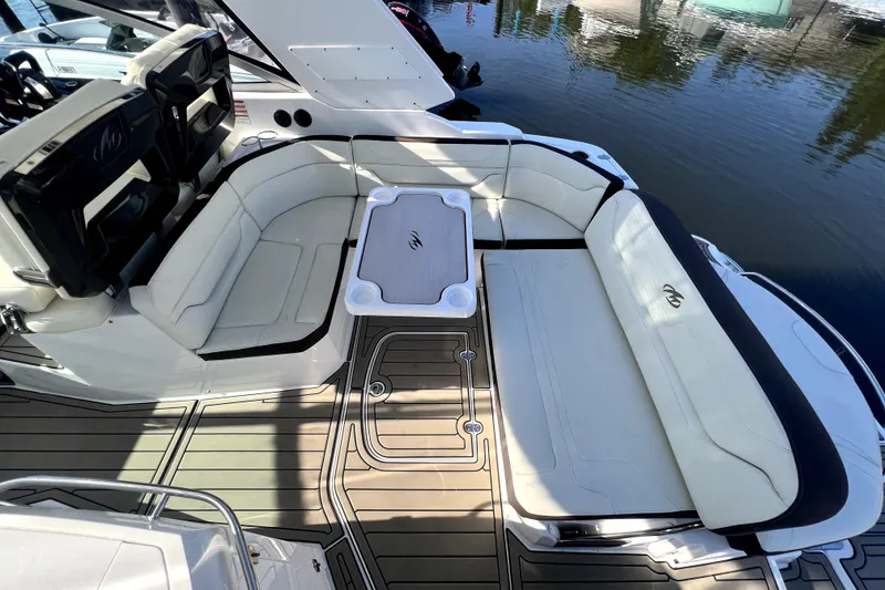 Slide: The Image of 2018 Monterey 355 Sport Yacht interior with white seating and table on deck. - 107