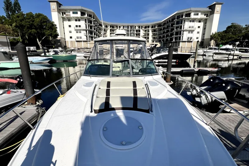 Slide: The Image of 2018 Monterey 355 Sport Yacht docked at marina with modern buildings in background. - 129