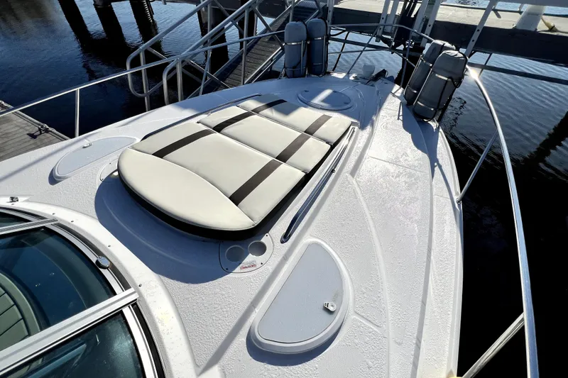 Slide: The Image of 2018 Monterey 355 Sport Yacht deck with sunpad and sleek design at dock. - 71
