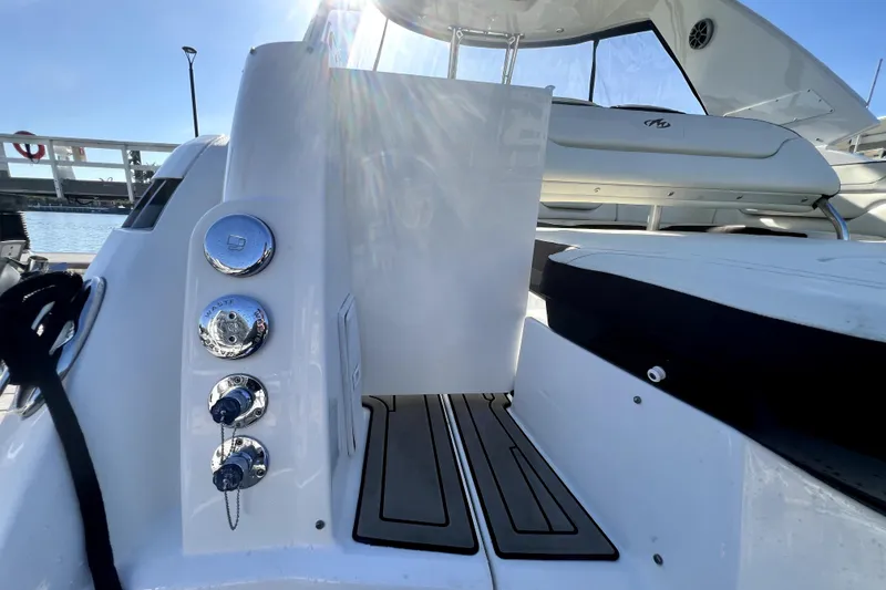 Slide: The Image of 2018 Monterey 355 Sport Yacht deck with seating and chrome fixtures in sunlight. - 26