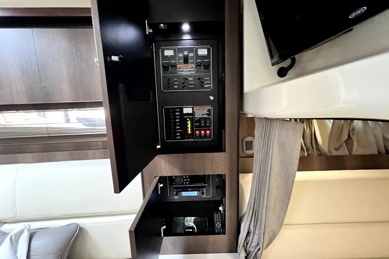 Slide: The Image of Electrical panel inside 2018 Monterey 355 Sport Yacht, featuring modern controls and sleek cabinetry. - 78