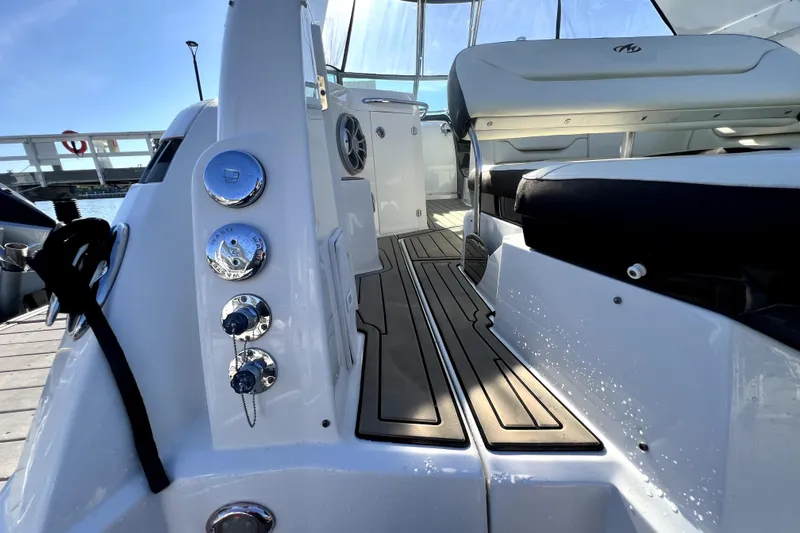 Slide: The Image of 2018 Monterey 355 Sport Yacht interior with sleek seating and polished controls. - 27