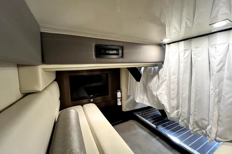 Slide: The Image of Interior of 2018 Monterey 355 Sport Yacht with TV, seating, and curtains. - 80
