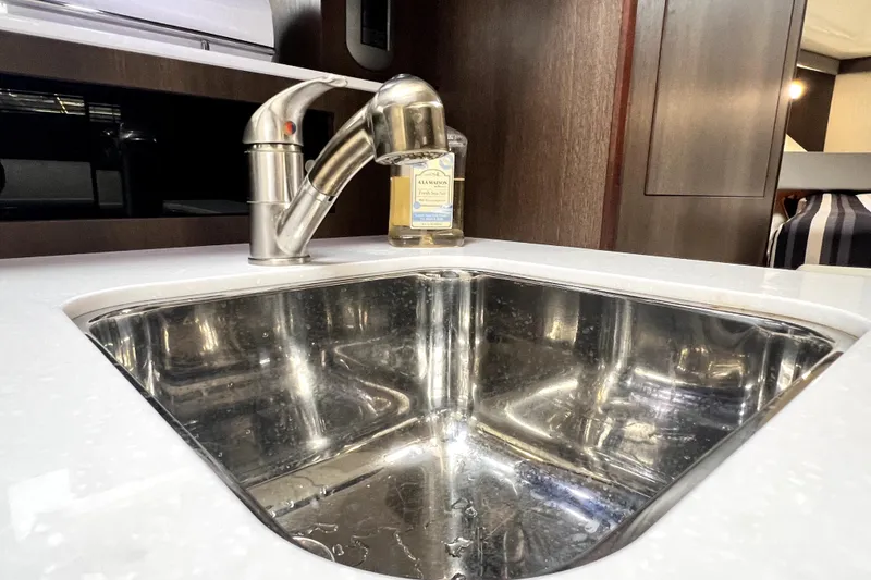 Slide: The Image of Stainless steel sink and faucet in 2018 Monterey 355 Sport Yacht interior. - 96