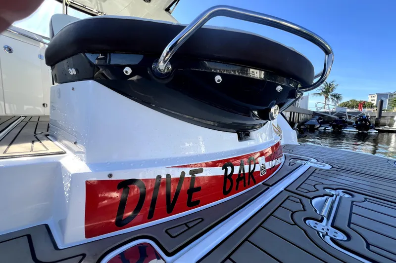 Slide: The Image of 2018 Monterey 355 Sport Yacht with "Dive Bar" label on deck, docked by water. - 29