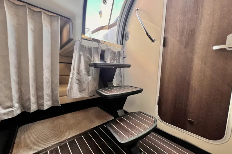Slide: The Image of Interior stairs of 2018 Monterey 355 Sport Yacht with wooden steps and curtains. - 55