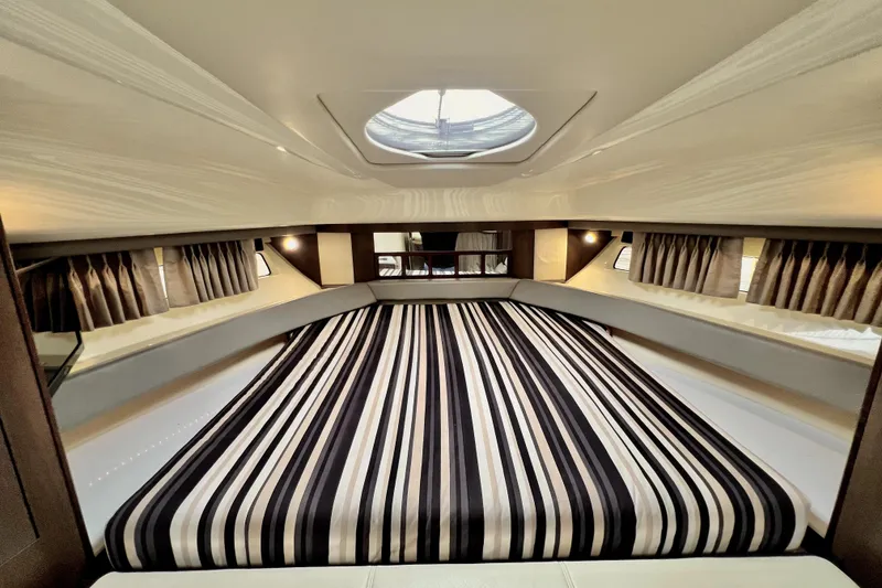 Slide: The Image of Luxurious interior of 2018 Monterey 355 Sport Yacht with striped bedding and elegant lighting. - 93