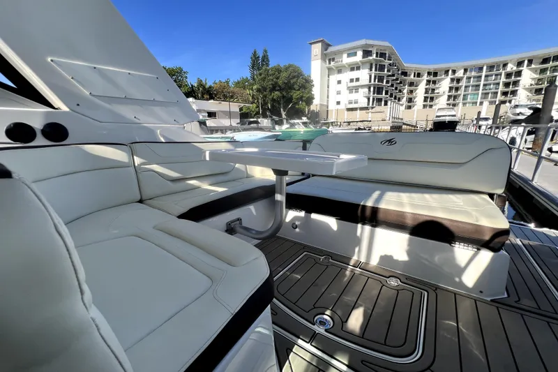 Slide: The Image of Luxurious seating area on a 2018 Monterey 355 Sport Yacht, docked near modern buildings. - 122