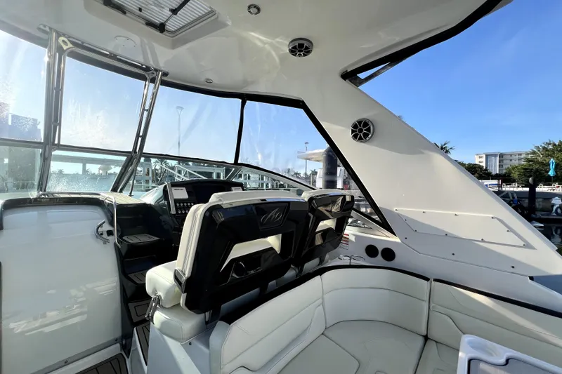 Slide: The Image of Interior view of a 2018 Monterey 355 Sport Yacht, showcasing sleek seating and modern controls. - 134