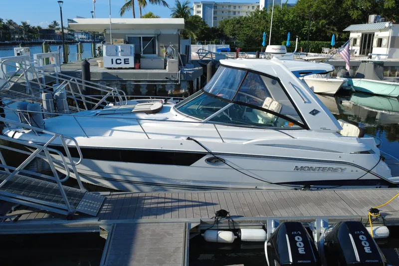 Slide: The Image of 2018 Monterey 355 Sport Yacht docked at marina with palm trees and boats. - 14