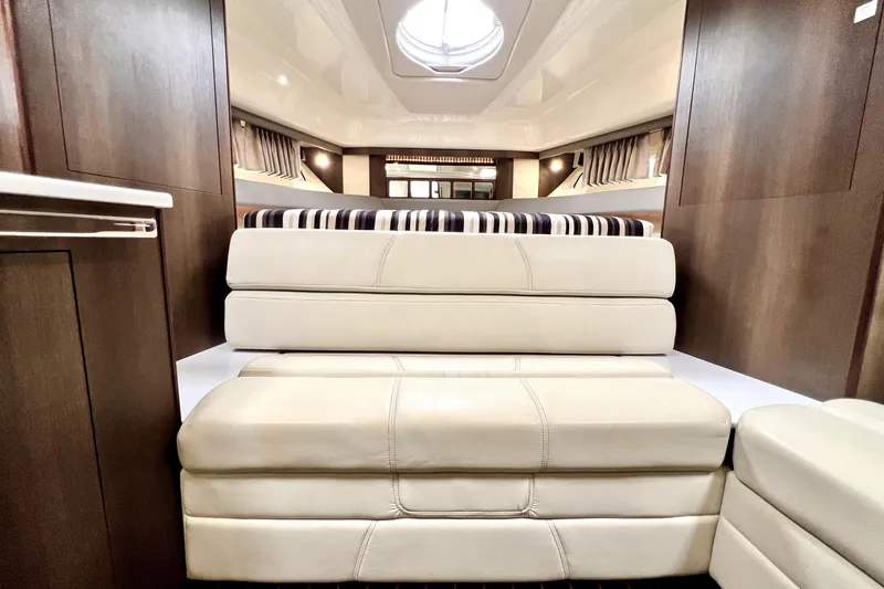 Slide: The Image of Interior of 2018 Monterey 355 Sport Yacht with plush seating and elegant wood finishes. - 92