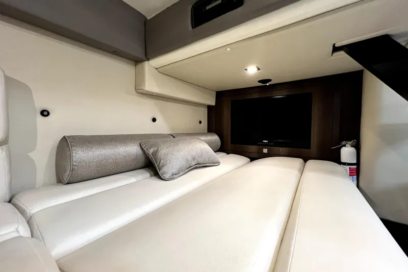 Slide: The Image of Interior of 2018 Monterey 355 Sport Yacht with plush seating and TV. - 69