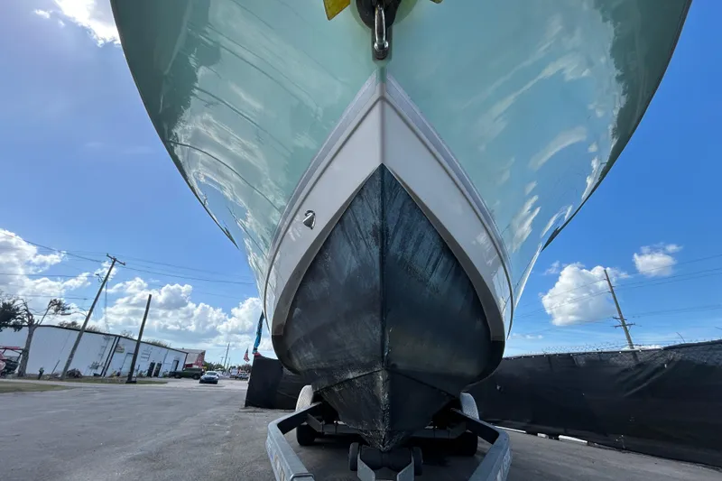 Slide: The Image of 2018 NauticStar 28 XS boat on trailer, viewed from below against blue sky. - 6