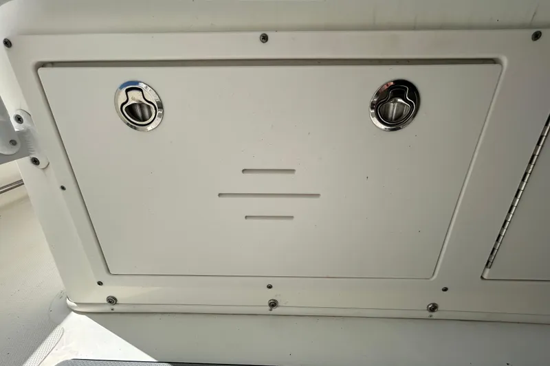 Slide: The Image of 2018 NauticStar 28 XS boat compartment with stainless steel latches. - 98
