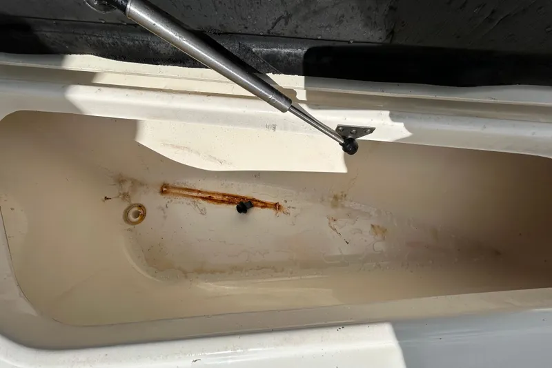 Slide: The Image of Open storage compartment of 2018 NauticStar 28 XS boat, showing interior details. - 94