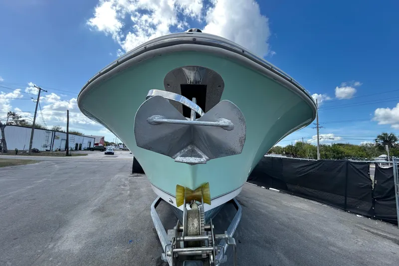 Slide: The Image of 2018 NauticStar 28 XS boat on trailer, viewed from front under blue sky. - 7