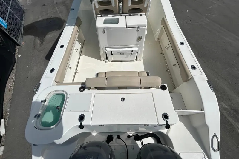 Slide: The Image of 2018 NauticStar 28 XS boat interior with seating, storage, and livewell. - 9