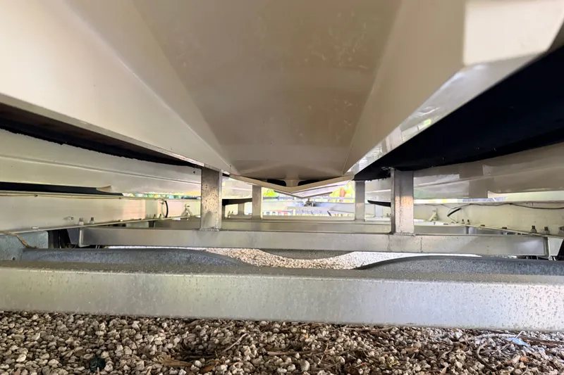 Slide: The Image of Underneath view of a 2023 SCB S22 boat on a trailer, showing hull and support structure. - 17