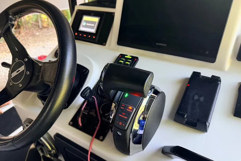 Slide: The Image of Steering wheel and controls of 2023 SCB S22 boat, featuring modern navigation technology. - 11