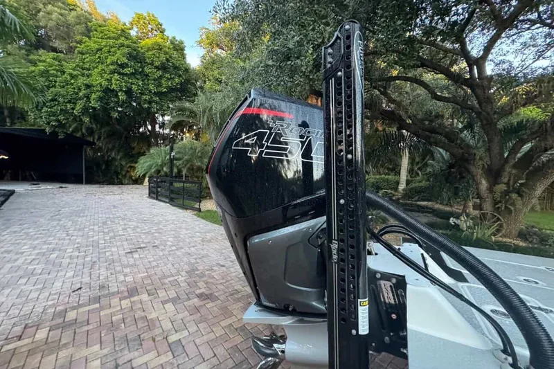 Slide: The Image of 2023 SCB S22 boat with powerful 450R engine in a lush outdoor setting. - 6