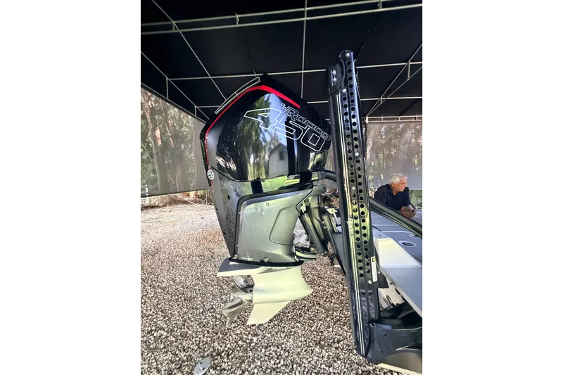 Slide: The Image of 2023 SCB S22 boat with powerful 450 outboard motor under a canopy. - 9
