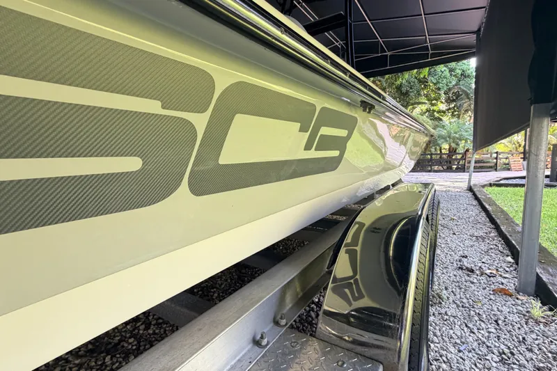 Slide: The Image of 2023 SCB S22 boat on trailer, showcasing sleek design and branding. - 13