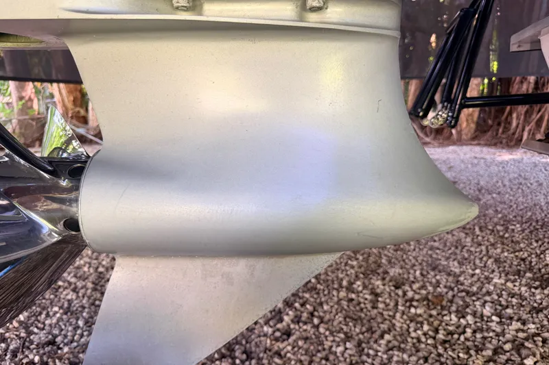 Slide: The Image of Close-up of a 2023 SCB S22 boat propeller and lower unit on gravel. - 15