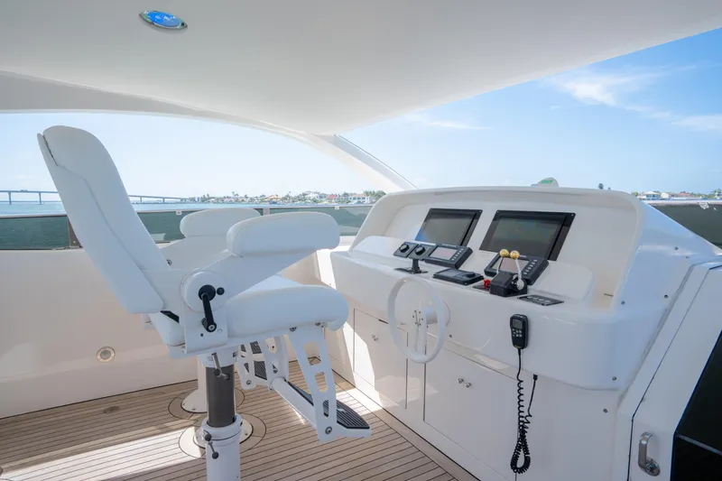 Slide: The Image of Luxurious helm of 2001 Lazzara 94 yacht with modern navigation equipment and white captain's chair. - 39