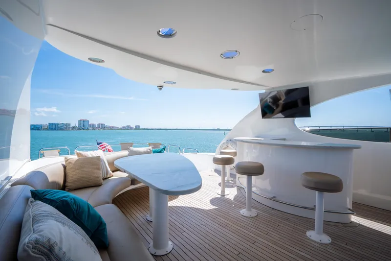 Slide: The Image of Luxurious 2001 Lazzara 94 yacht deck with seating, bar, and ocean view. - 38