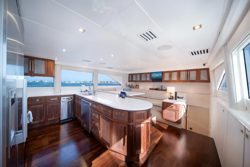 Slide: The Image of Luxurious kitchen interior of 2001 Lazzara 94 yacht with modern wood cabinetry and ocean view. - 13