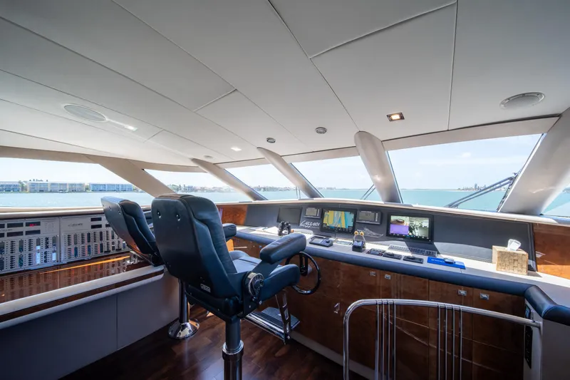 Slide: The Image of Luxurious helm of 2001 Lazzara 94 yacht with advanced navigation systems and ocean view. - 17