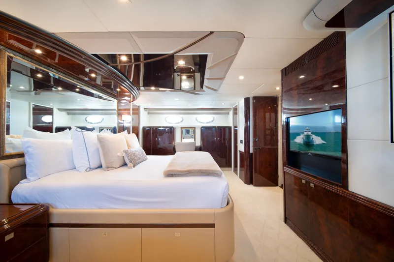 Slide: The Image of Luxurious bedroom interior of 2001 Lazzara 94 yacht with elegant wood finishes. - 24