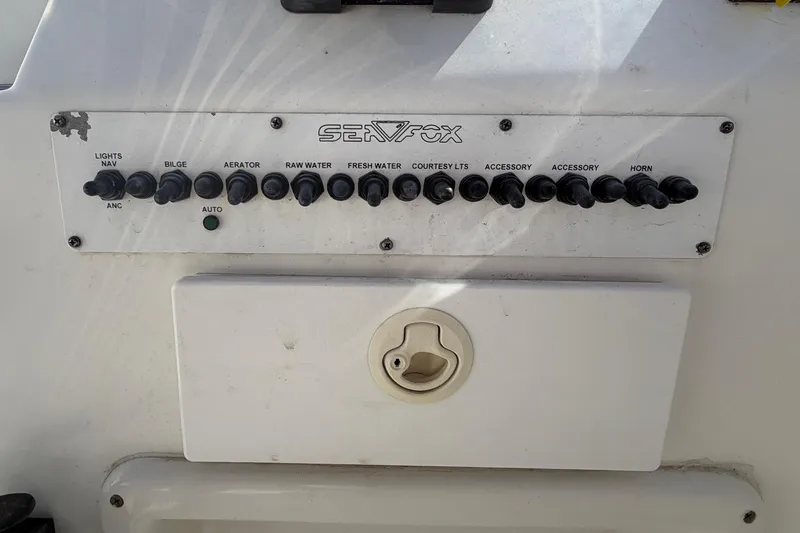 Slide: The Image of Control panel of a 2008 Sea Fox 216 Dual Console boat with various switches. - 25