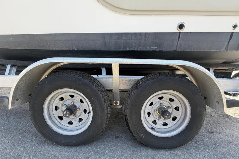 Slide: The Image of Trailer wheels supporting a 2008 Sea Fox 216 Dual Console boat. - 57
